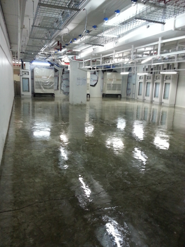 the inside of a large industrial building with water on the floor