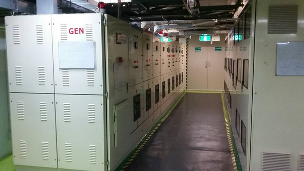 a large room with several electrical panels on the wall